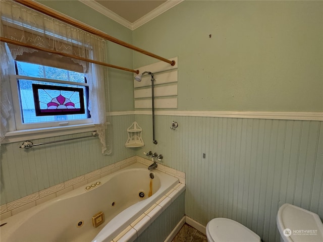 bathroom with tiled tub, crown molding, and toilet