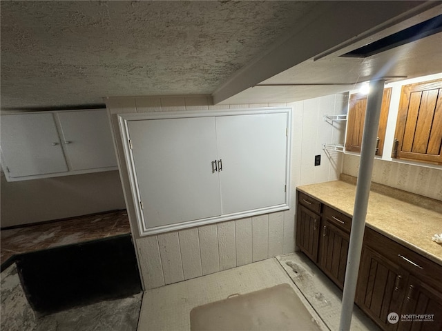 bathroom featuring wooden walls and vanity