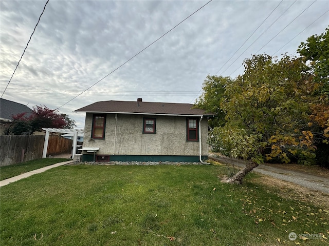 back of house with a lawn