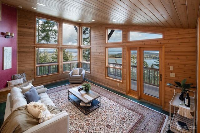 living room featuring a water view, wooden ceiling, and plenty of natural light