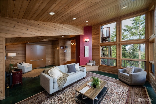 living room featuring wood ceiling, wood walls, a healthy amount of sunlight, and high vaulted ceiling