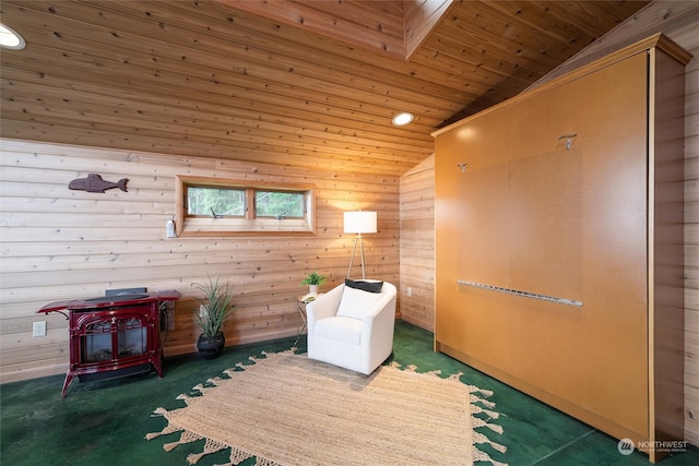 sitting room featuring high vaulted ceiling, a wood stove, wooden walls, and wooden ceiling