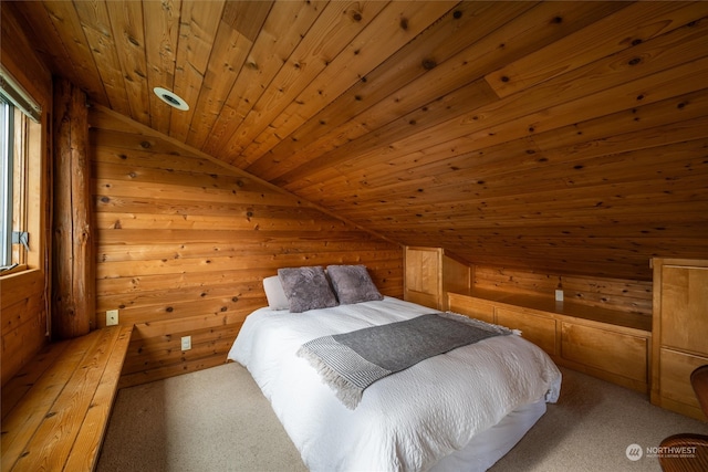 carpeted bedroom with lofted ceiling, wood walls, and wood ceiling