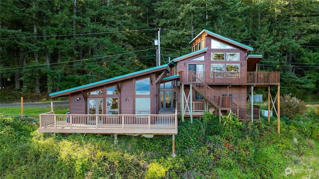 rear view of property with a wooden deck