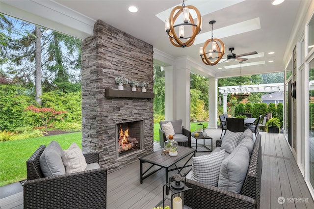 deck featuring an outdoor living space with a fireplace and ceiling fan