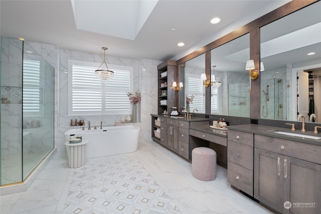 bathroom featuring a notable chandelier, tile walls, vanity, and plus walk in shower