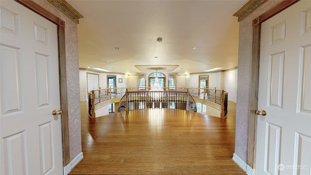 corridor featuring crown molding and hardwood / wood-style flooring