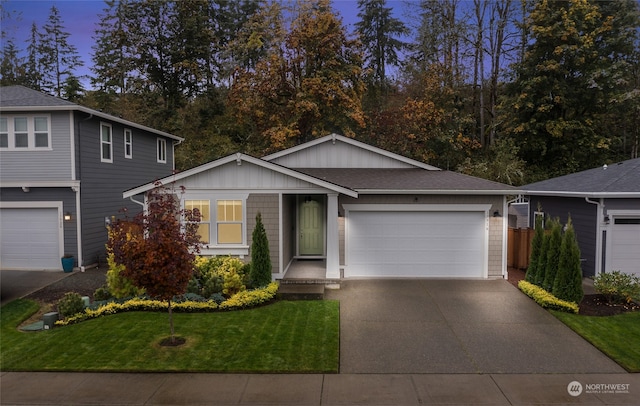 view of front of property with a yard and a garage