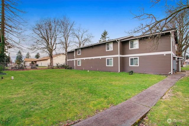 rear view of property with a yard