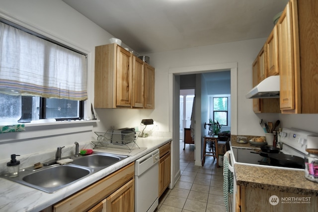 kitchen with white appliances, sink, and light tile patterned floors