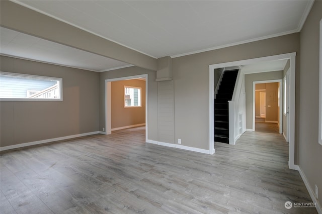 spare room with crown molding and light hardwood / wood-style floors