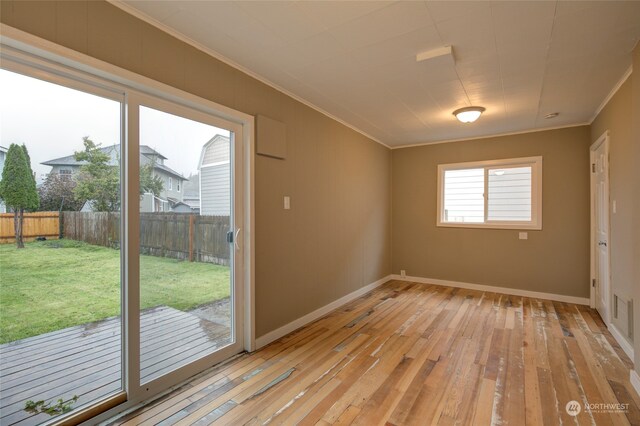 unfurnished room featuring ornamental molding and light wood-type flooring