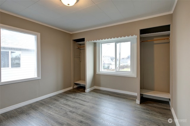 unfurnished bedroom with ornamental molding and hardwood / wood-style floors