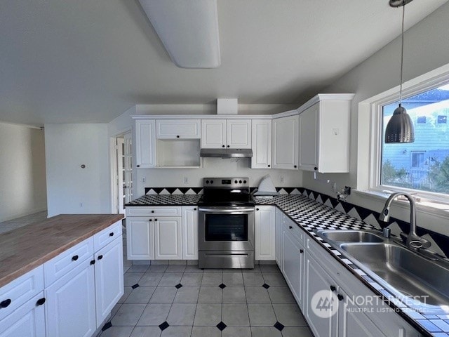 kitchen with sink, wooden counters, pendant lighting, white cabinets, and stainless steel electric range oven