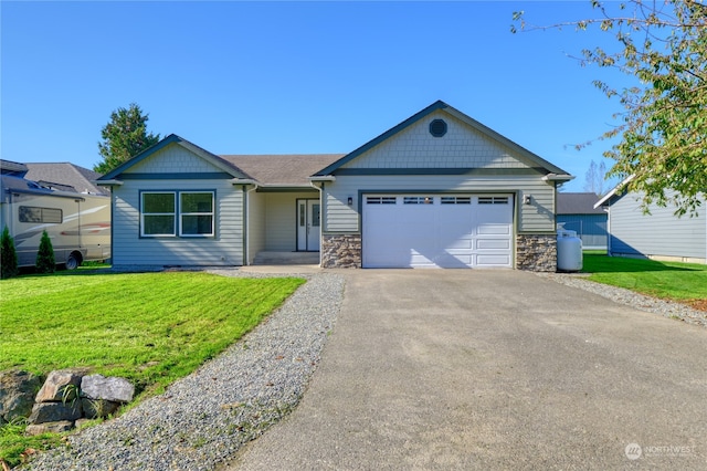 ranch-style house featuring a front yard and a garage