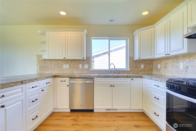 kitchen with tasteful backsplash, light wood-type flooring, white cabinetry, black gas range oven, and stainless steel dishwasher