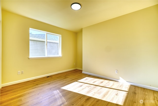 empty room featuring wood-type flooring