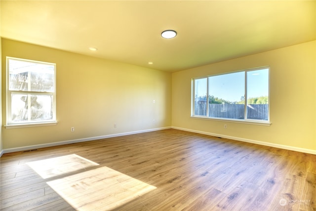 spare room with light hardwood / wood-style flooring