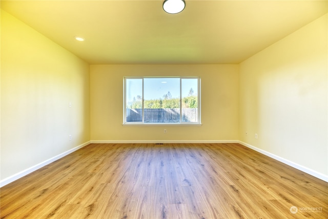 empty room with light hardwood / wood-style flooring