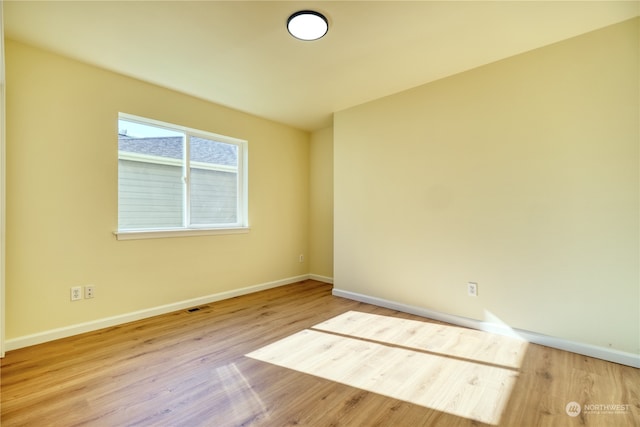 spare room with light wood-type flooring