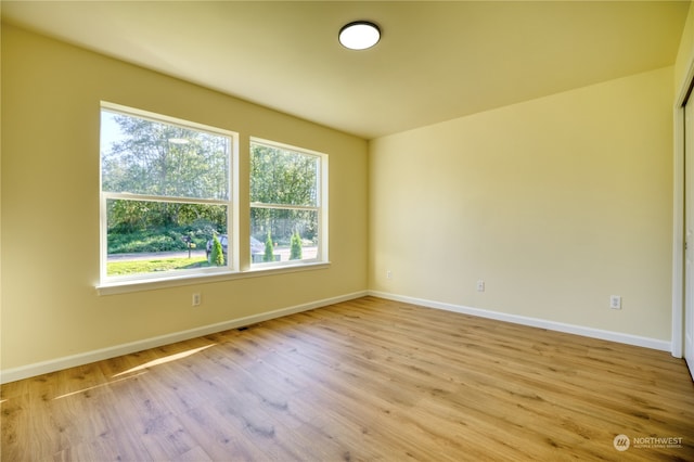 spare room with light wood-type flooring