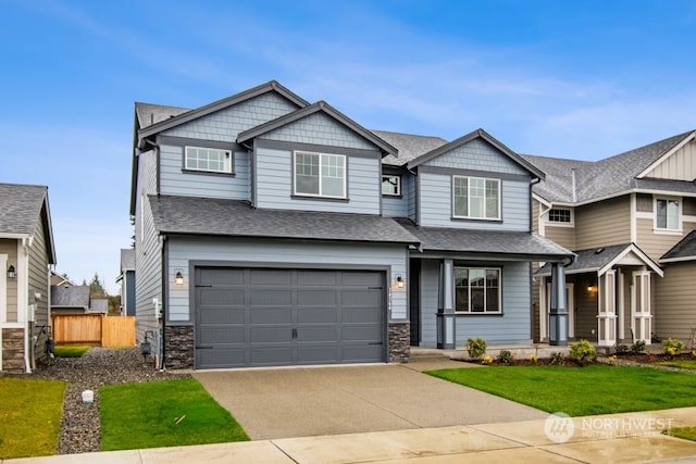 craftsman-style home with a front yard and a garage