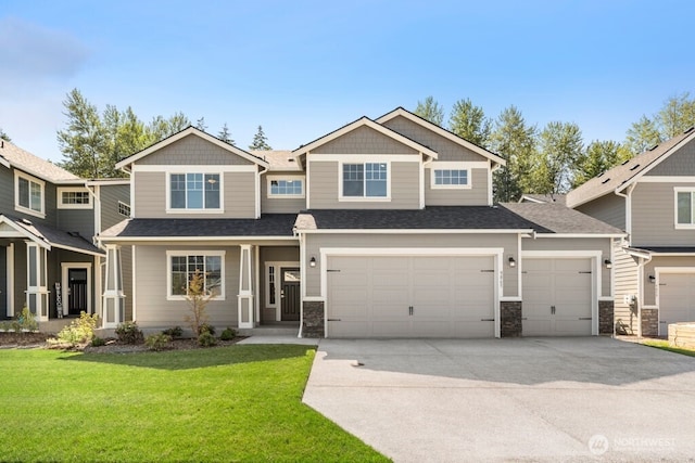 9865 Merrick St SE Unit 384, Yelm, WA 98597 - craftsman-style house with concrete driveway, a front lawn, a garage, stone siding, and a shingled roof