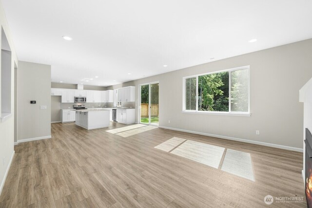 9865 Merrick St SE Unit 384, Yelm, WA 98597 - unfurnished living room with light wood-style flooring and recessed lighting