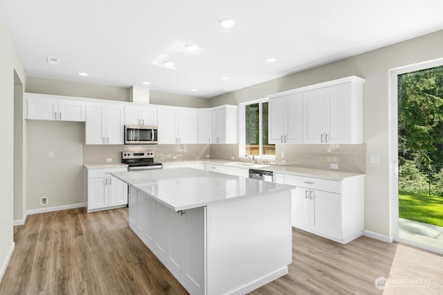9865 Merrick St SE Unit 384, Yelm, WA 98597 - kitchen with stainless steel appliances, healthy amount of natural light, light wood-type flooring, decorative backsplash, and recessed lighting
