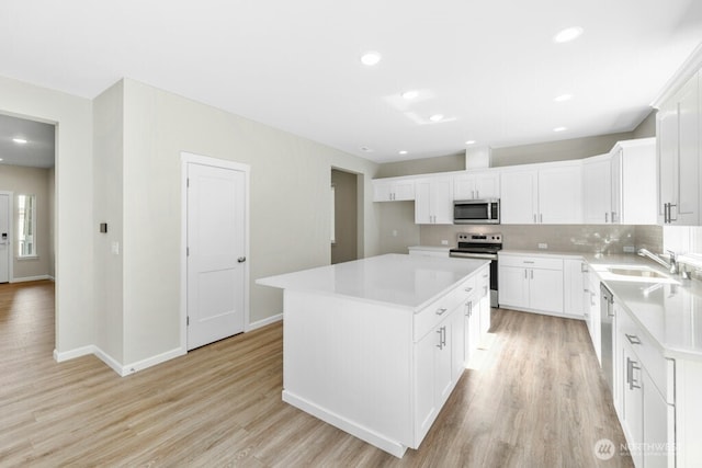 9865 Merrick St SE Unit 384, Yelm, WA 98597 - kitchen with stainless steel appliances, light wood-type flooring, tasteful backsplash, light countertops, and recessed lighting