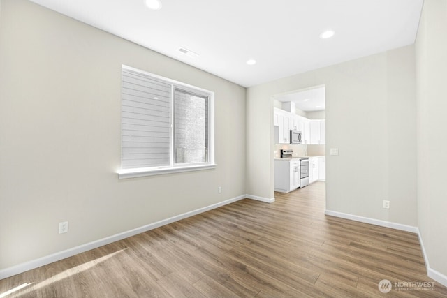 9865 Merrick St SE Unit 384, Yelm, WA 98597 - spare room with wood finished floors and recessed lighting