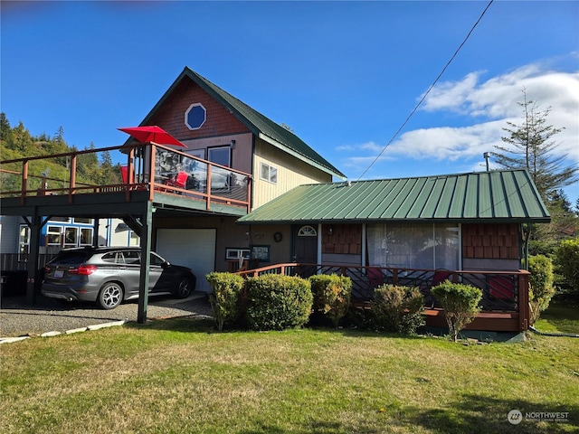 61 Salt Air St, Clallam Bay, WA 98326 - view of front of house featuring a garage, a front lawn, metal roof, and driveway