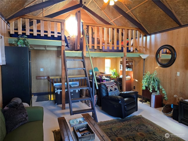 living room featuring vaulted ceiling, ceiling fan, and wood walls