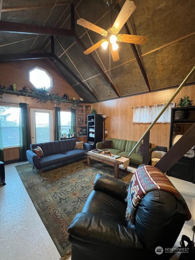 living room featuring ceiling fan, wooden walls, and vaulted ceiling