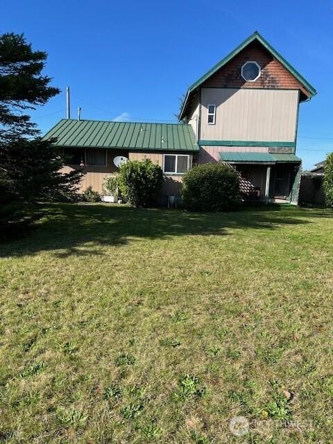 61 Salt Air St, Clallam Bay, WA 98326 - view of property exterior with a lawn and metal roof