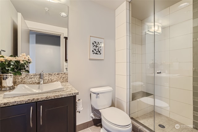 bathroom with vanity, tile patterned floors, toilet, and an enclosed shower