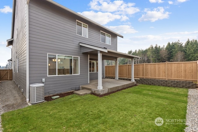 back of property featuring a lawn, a patio area, and central air condition unit