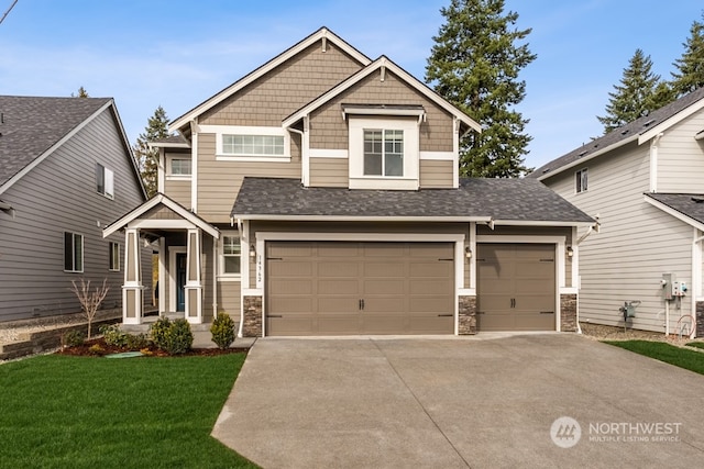 craftsman inspired home featuring a garage and a front lawn