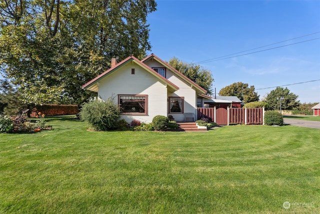 view of side of home with a yard