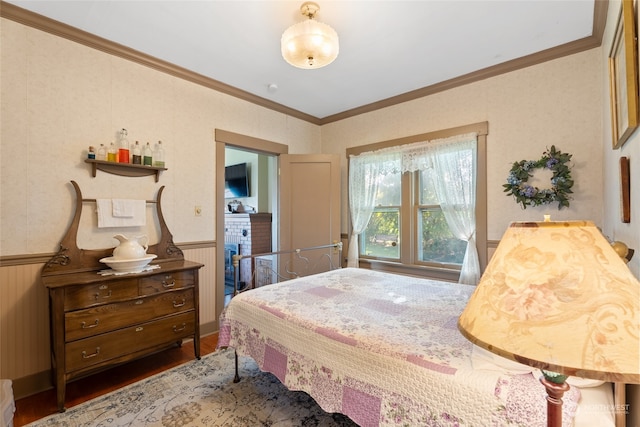 bedroom with crown molding and dark wood-type flooring