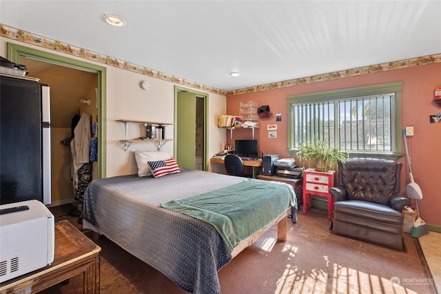 bedroom featuring refrigerator