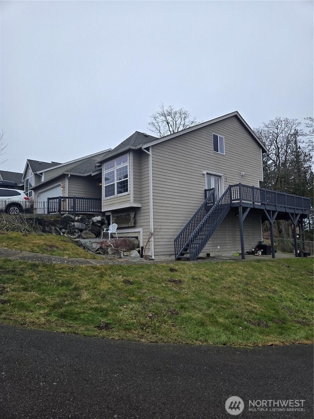 view of home's exterior featuring a yard and a deck