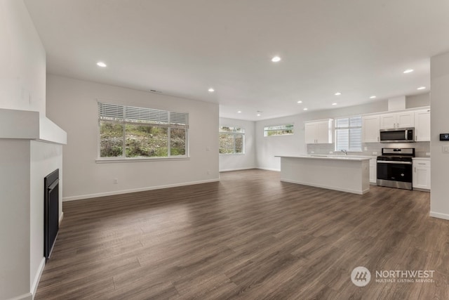 unfurnished living room featuring dark wood-type flooring