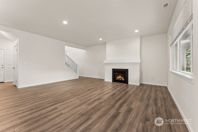 unfurnished living room featuring dark wood-type flooring