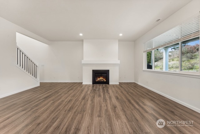 unfurnished living room with dark hardwood / wood-style flooring