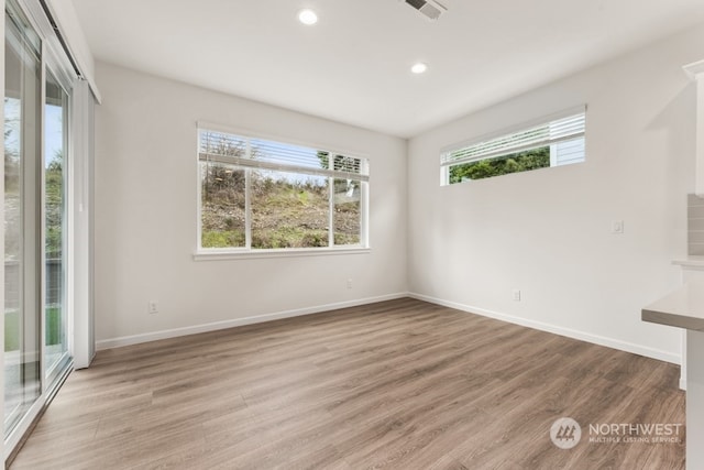 spare room with light hardwood / wood-style flooring