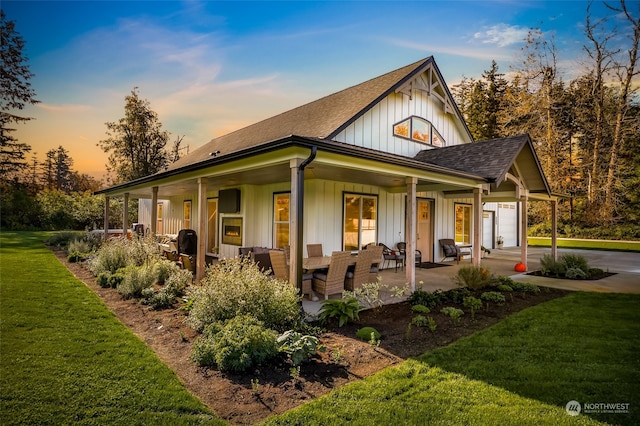 view of front of house with covered porch and a lawn