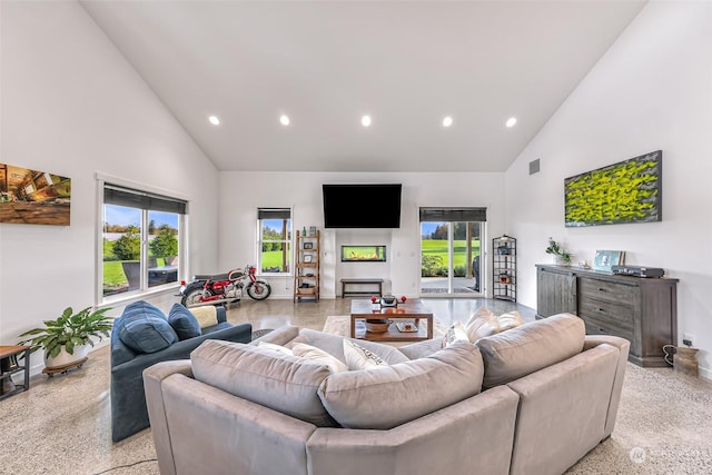 living area with high vaulted ceiling, a healthy amount of sunlight, and recessed lighting