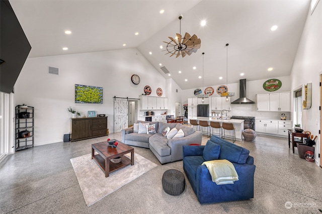 living room with ceiling fan, high vaulted ceiling, sink, and a barn door