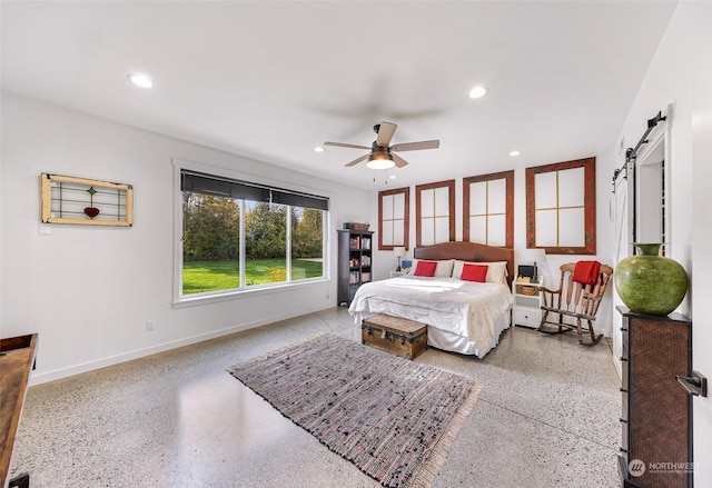 bedroom featuring baseboards, recessed lighting, a barn door, and speckled floor